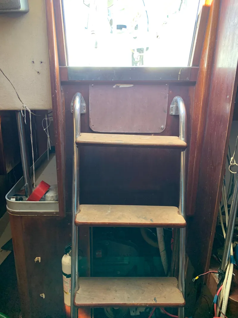 Slide: The Image of Interior view of 1978 Camper & Nicholsons Sloop, featuring wooden steps and metal handrails. - 15