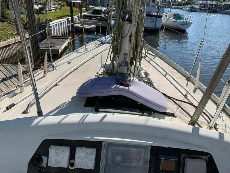 Slide: The Image of 1978 Camper & Nicholsons Sloop deck view at marina, showcasing rigging and control panel. - 17