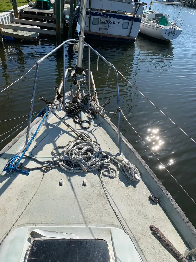 Slide: The Image of 1978 Camper & Nicholsons Sloop with ropes on deck, docked in a marina. - 18