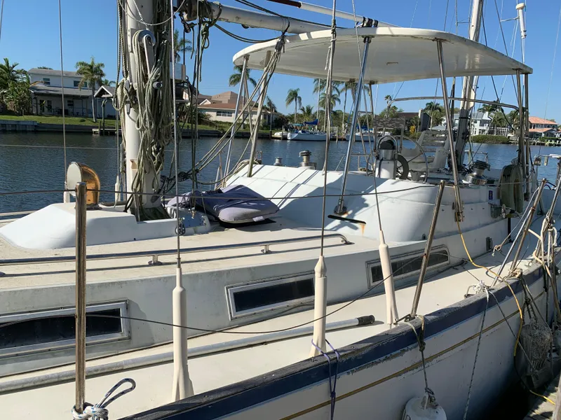 Slide: The Image of 1978 Camper & Nicholsons Sloop docked by waterfront homes, showcasing deck and rigging. - 2