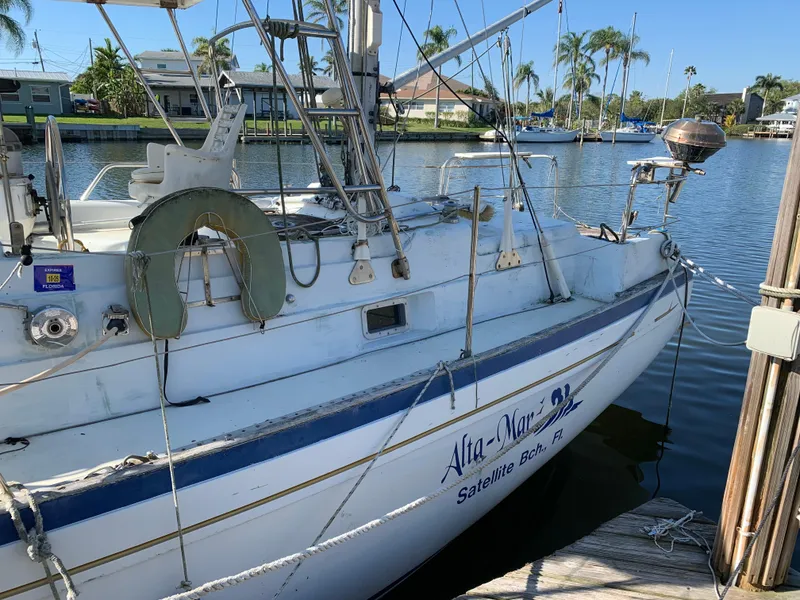 Slide: The Image of 1978 Camper & Nicholsons Sloop docked, featuring a lifebuoy and marina backdrop. - 3
