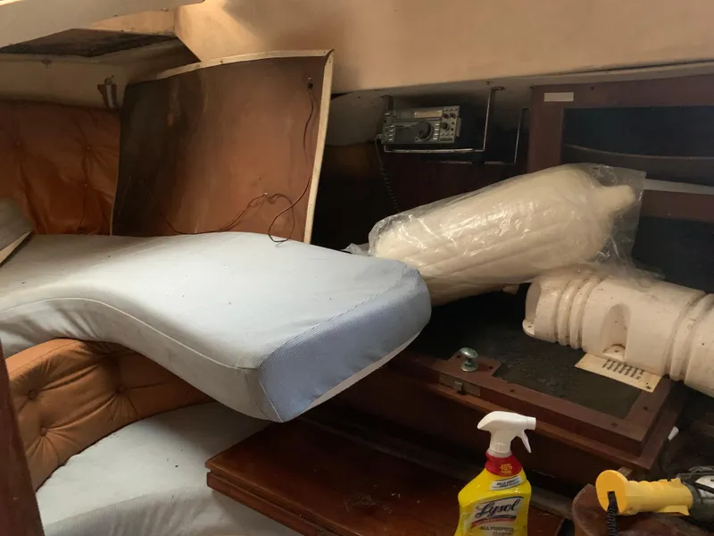 Slide: The Image of 1978 Camper & Nicholsons Sloop interior with cushions, radio, and cleaning supplies. - 8