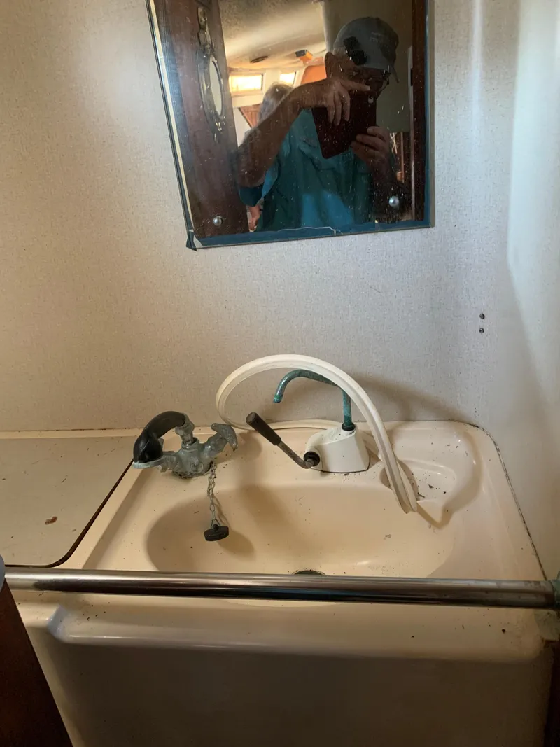 Slide: The Image of 1978 Camper & Nicholsons Sloop bathroom sink with mirror and faucet. - 9