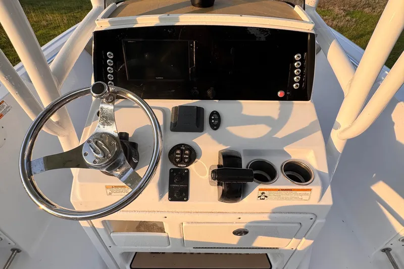 Slide: The Image of 2019 Sportsman 231 Heritage Platinum boat console with steering wheel and controls. - 10
