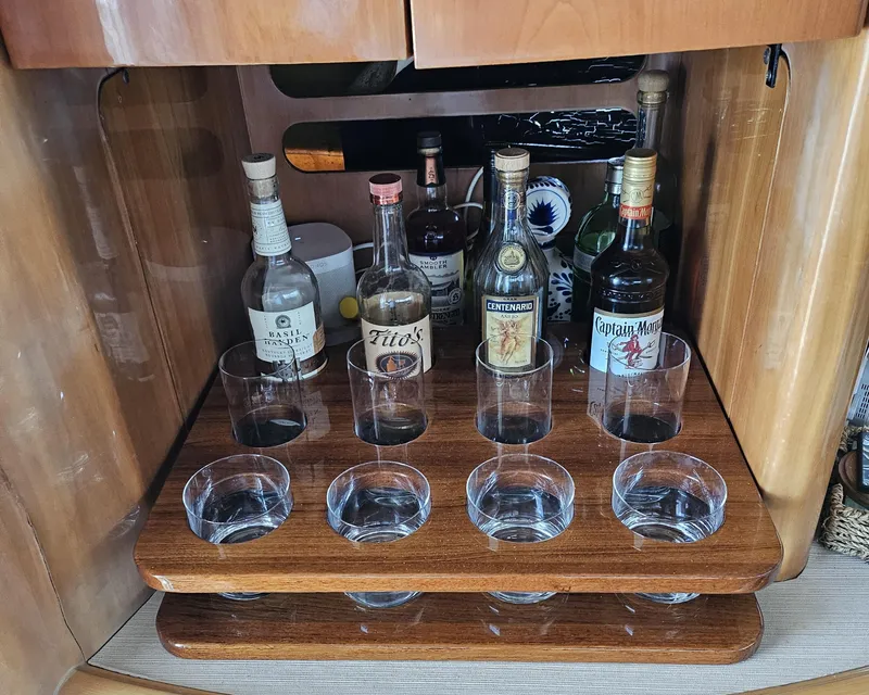 Slide: The Image of Bar setup on 1998 Viking Princess 46 Flybridge Sport Cruiser with liquor bottles and glasses. - 22