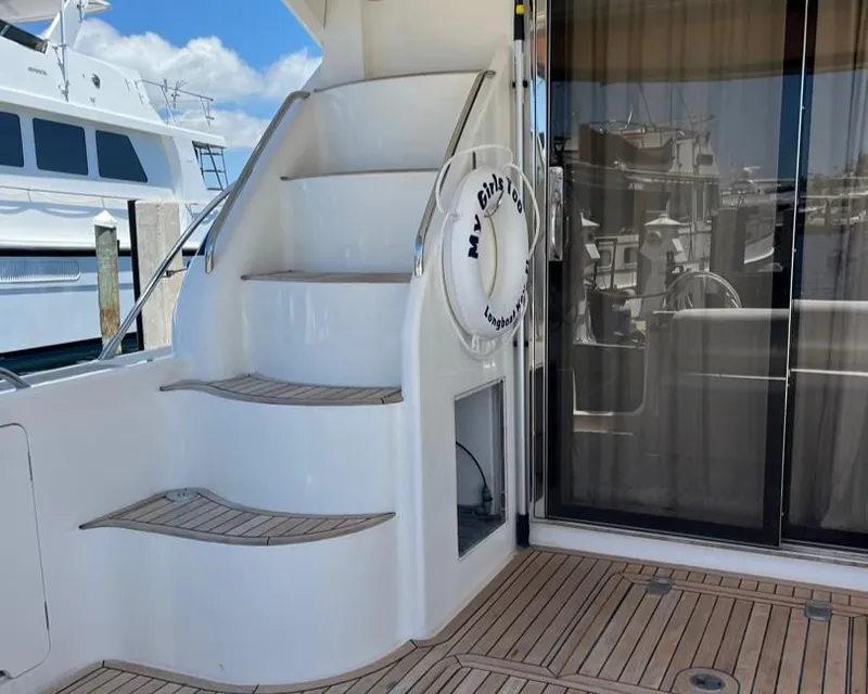 Slide: The Image of Staircase on 1998 Viking Princess 46 Flybridge Sport Cruiser with wooden deck and life ring. - 25