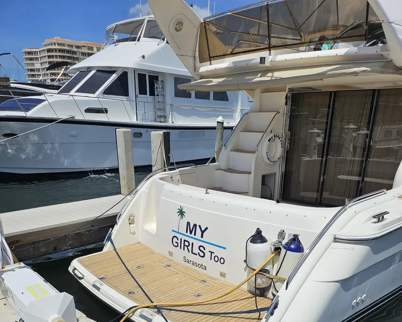 Slide: The Image of 1998 Viking Princess 46 Flybridge Sport Cruiser docked, featuring "My Girls Too" nameplate, Sarasota. - 26