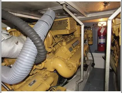 Slide: The Image of Engine room of 1998 Viking Princess 46 Flybridge Sport Cruiser with yellow machinery and fire extinguisher. - 33