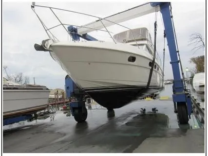Slide: The Image of 1998 Viking Princess 46 Flybridge Sport Cruiser on a boat lift at a marina. - 36