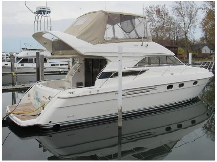 Slide: The Image of 1998 Viking Princess 46 Flybridge Sport Cruiser docked at marina. - 4
