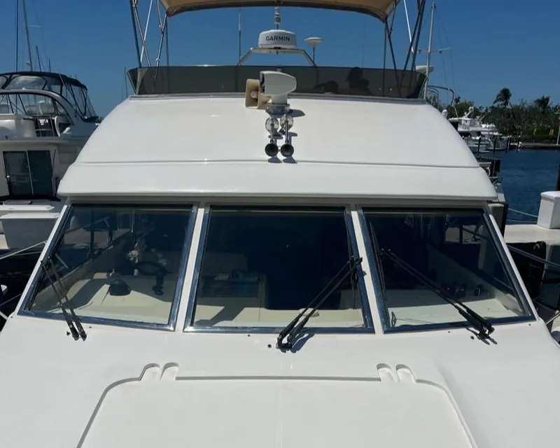 Slide: The Image of 1998 Viking Princess 46 Flybridge Sport Cruiser docked at marina, front view. - 5