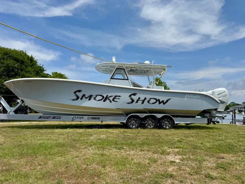 The Image of 2020 Yellowfin 39 Offshore boat named "Smoke Show" on a trailer, parked on grass. - 1