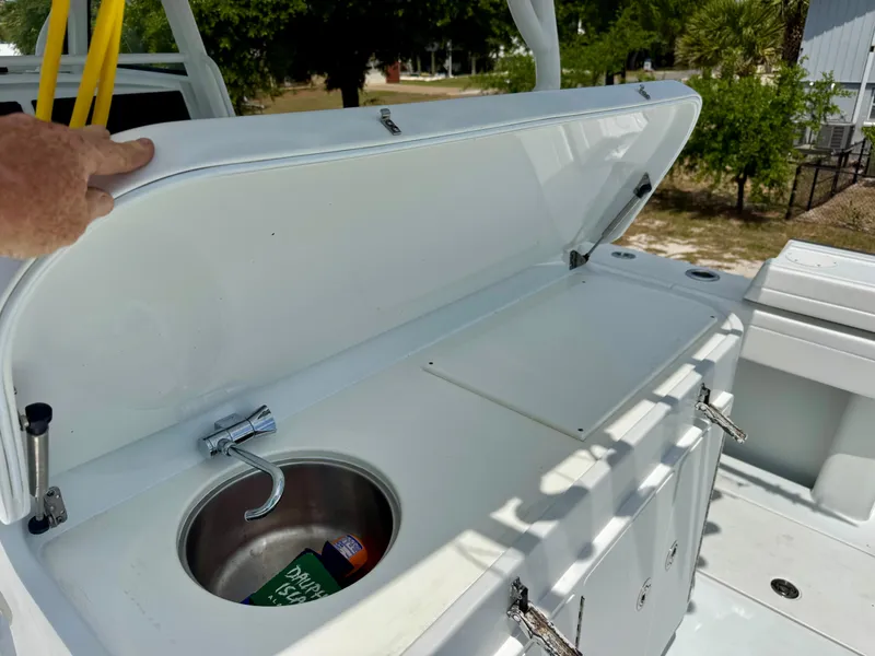 Slide: The Image of 2020 Yellowfin 39 Offshore boat with open storage compartment and sink. - 13
