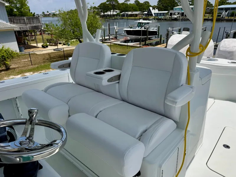 Slide: The Image of 2020 Yellowfin 39 Offshore boat with white cushioned seating and steering wheel. - 17