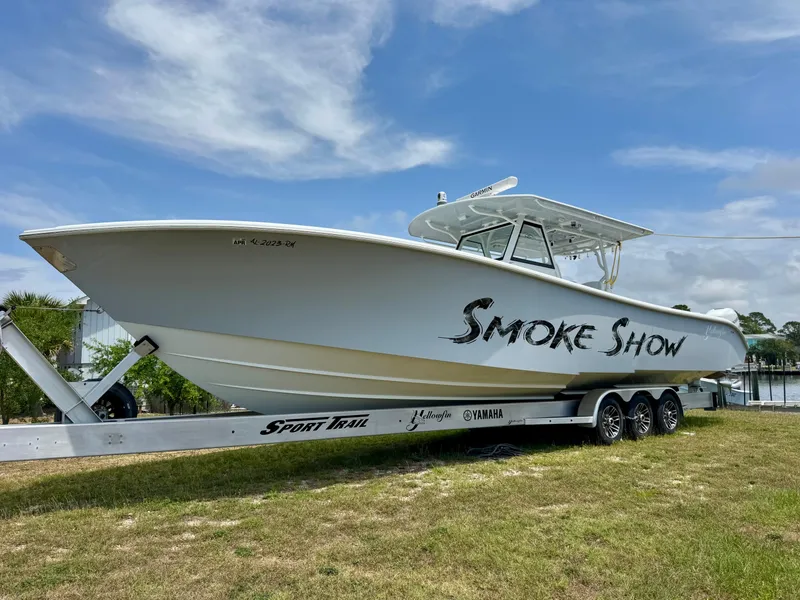 Slide: The Image of 2020 Yellowfin 39 Offshore boat named "Smoke Show" on a trailer, side view. - 2