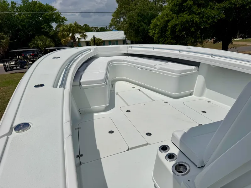 Slide: The Image of 2020 Yellowfin 39 Offshore boat with spacious deck and seating, surrounded by lush greenery. - 20