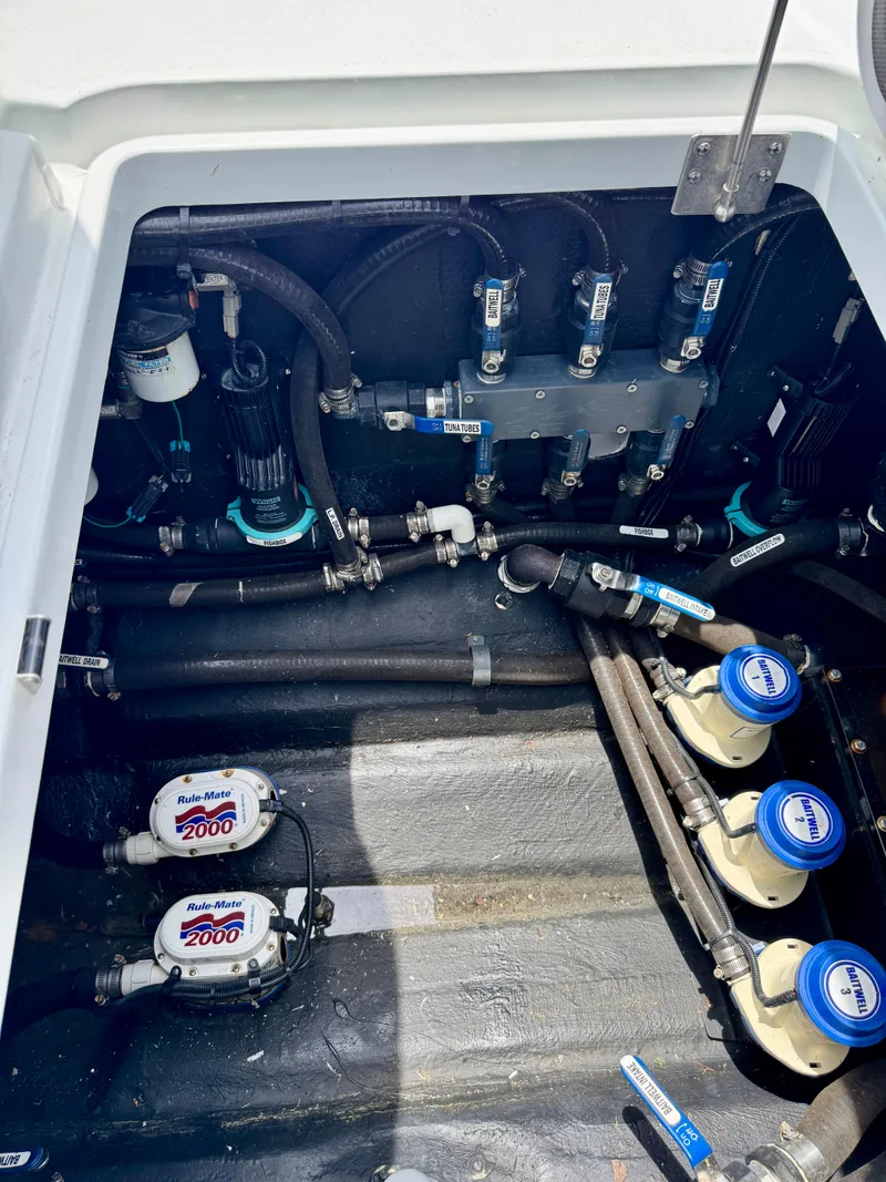 Slide: The Image of 2020 Yellowfin 39 Offshore boat engine compartment with pumps and hoses. - 28