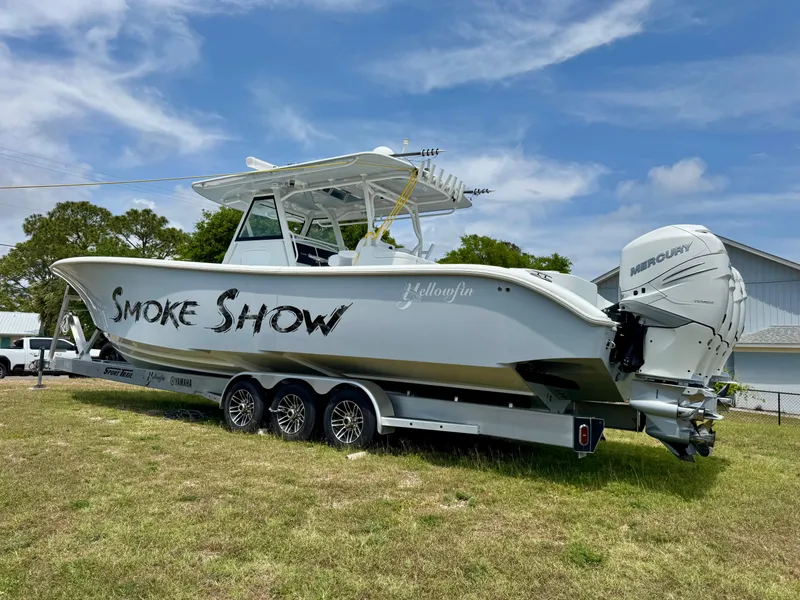 Slide: The Image of 2020 Yellowfin 39 Offshore boat on trailer with "Smoke Show" text, parked on grass. - 3