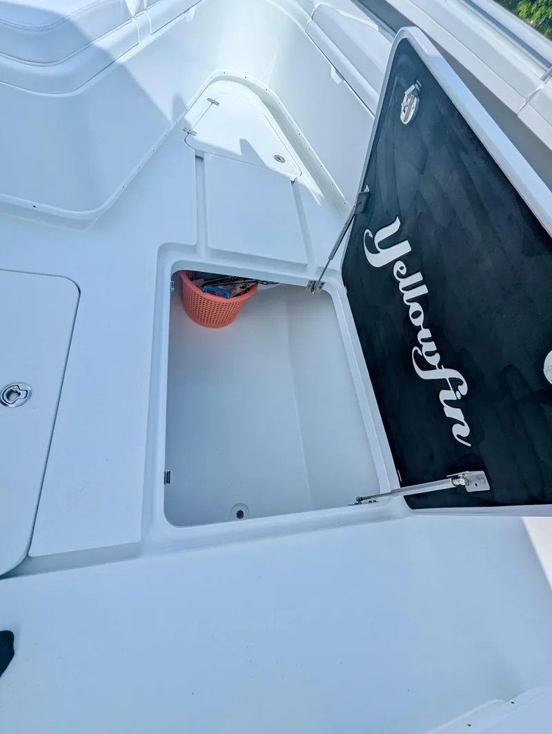 Slide: The Image of 2020 Yellowfin 39 Offshore boat storage compartment with open hatch. - 32