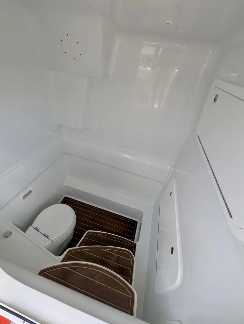 Slide: The Image of 2020 Yellowfin 39 Offshore boat interior with toilet and wooden flooring. - 33