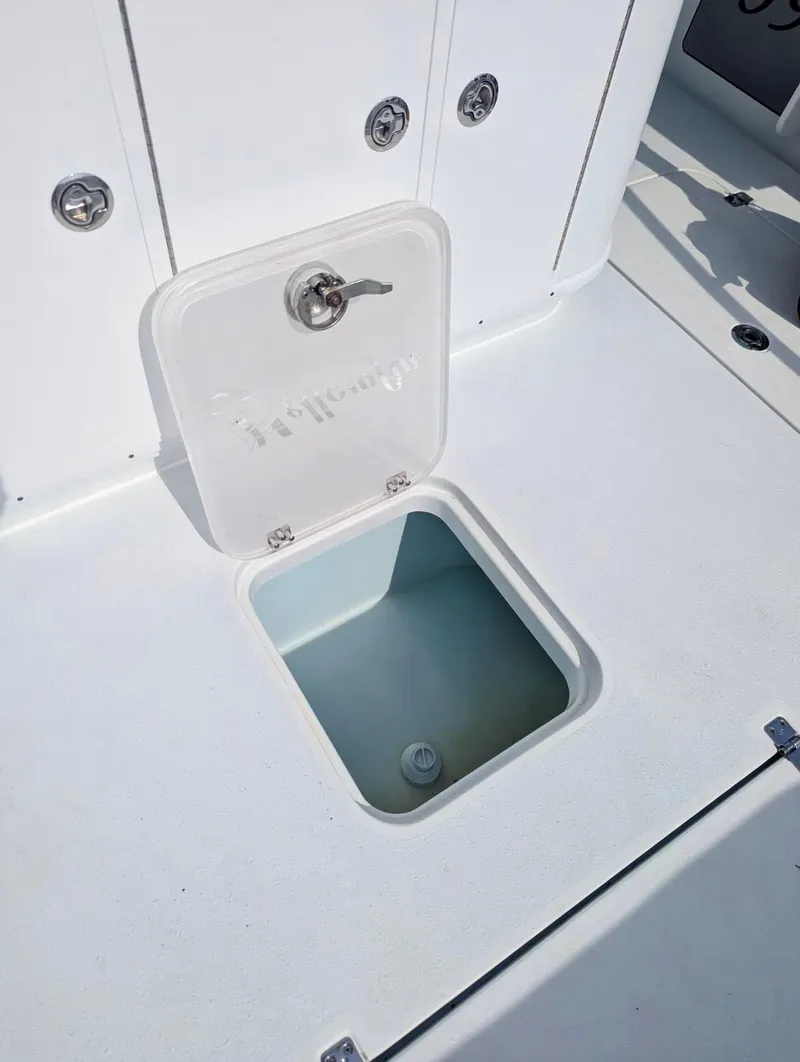 Slide: The Image of 2020 Yellowfin 39 Offshore boat storage compartment with open hatch, showcasing interior space. - 35