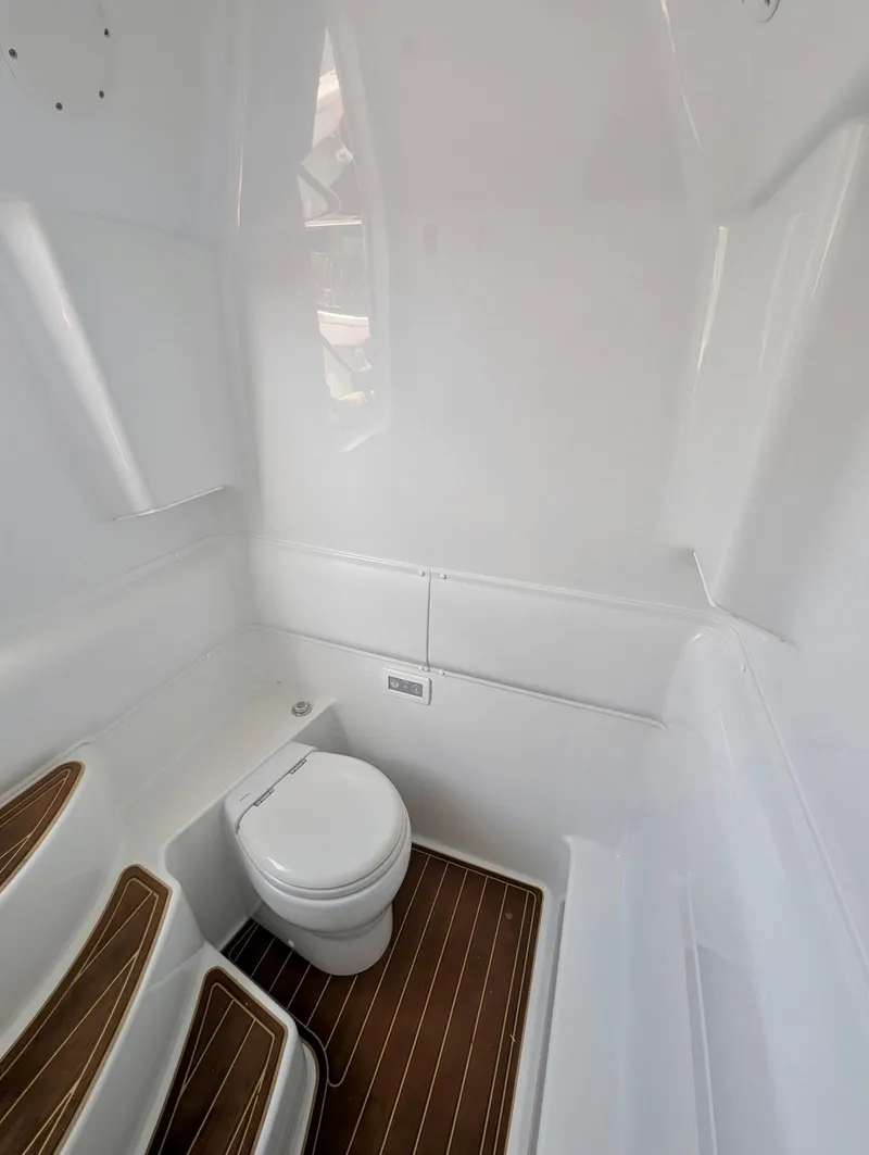 Slide: The Image of 2020 Yellowfin 39 Offshore boat interior with toilet and wooden flooring. - 37