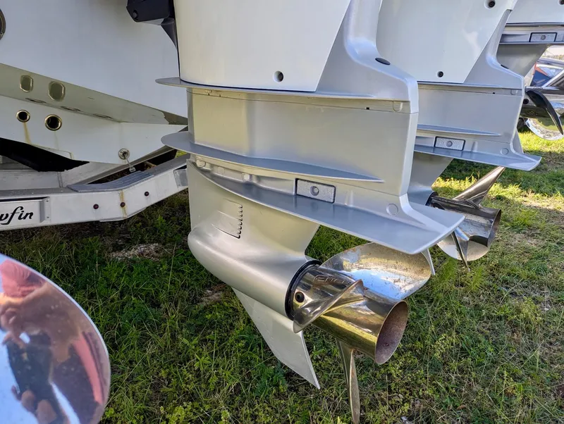 Slide: The Image of 2020 Yellowfin 39 Offshore boat engines and propellers on grass. - 40