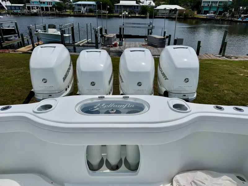 Slide: The Image of 2020 Yellowfin 39 Offshore boat with four powerful outboard engines docked by the water. - 9