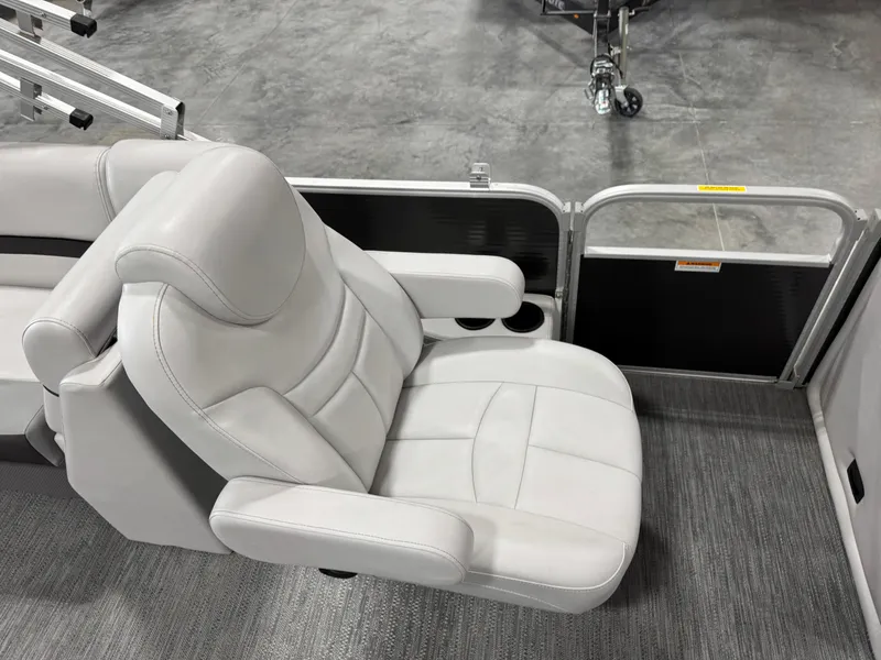 Slide: The Image of Luxurious seating on 2023 Sweetwater 2286 boat, featuring plush gray upholstery and armrests. - 12