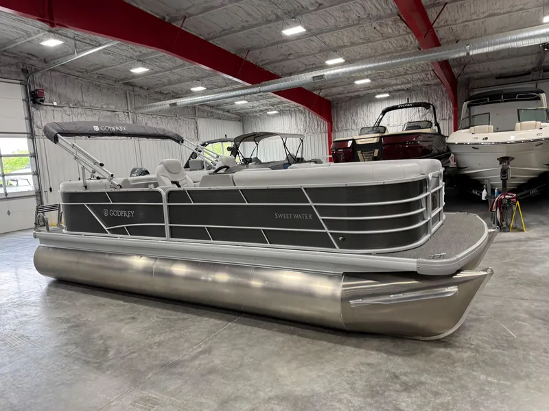 Slide: The Image of 2023 Sweetwater 2286 pontoon boat in a showroom, featuring sleek design and modern amenities. - 3