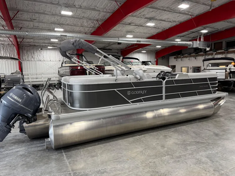 Slide: The Image of 2023 Sweetwater 2286 pontoon boat in a showroom with Yamaha outboard motor. - 4