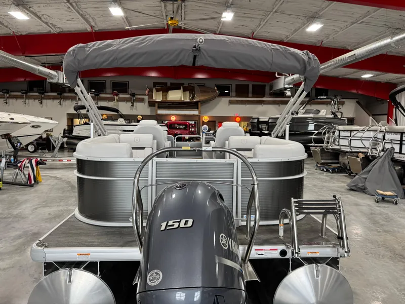 Slide: The Image of 2023 Sweetwater 2286 pontoon boat with 150 HP engine in a showroom. - 7