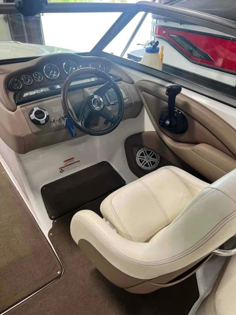 Slide: The Image of 2008 Cobalt 232 boat interior with steering wheel and dashboard controls. - 10