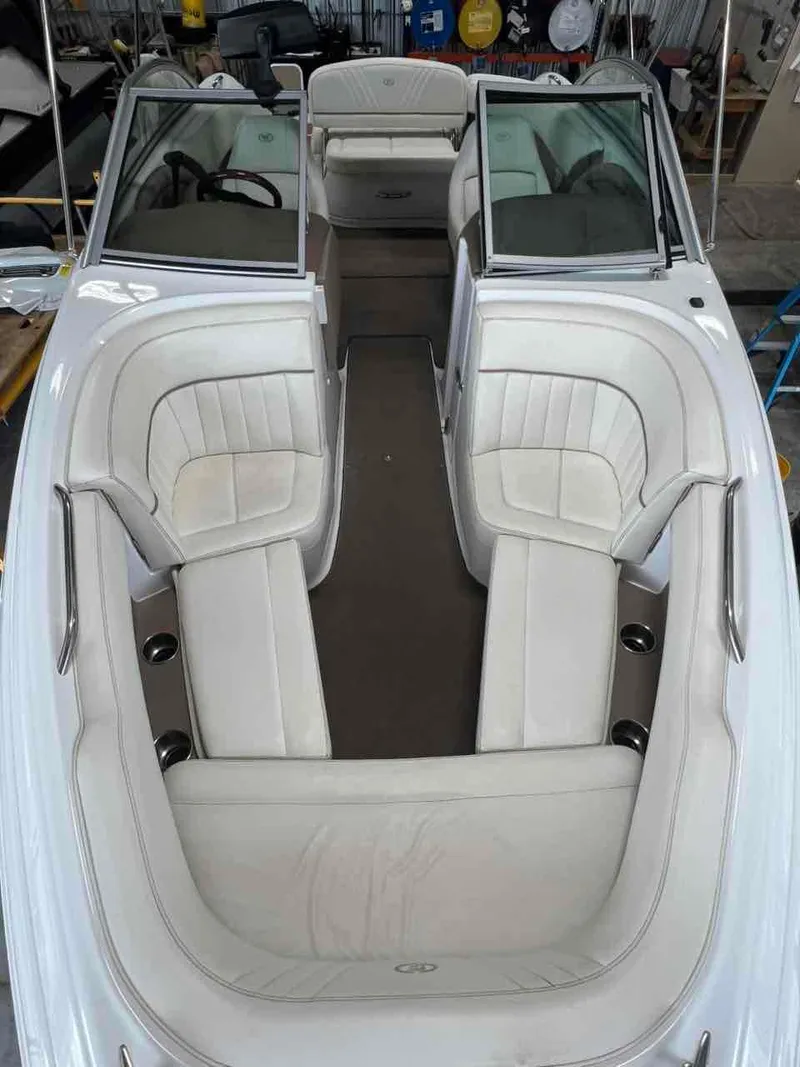 Slide: The Image of 2008 Cobalt 232 boat interior with white seating and open windshield. - 3