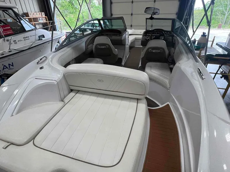 Slide: The Image of 2008 Cobalt 232 boat interior with white seating, in a garage setting. - 6