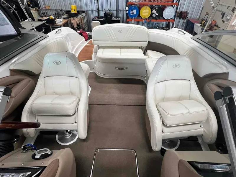 Slide: The Image of Interior of a 2008 Cobalt 232 boat with white leather seating and steering console. - 7
