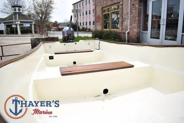 Slide: The Image of 1980 Carolina Skiff boat interior with wooden benches, displayed at Thayer's Marine. - 10