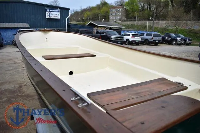 Slide: The Image of 1980 Carolina Skiff boat with wooden seats, displayed at Thayer's Marine dealership. - 12