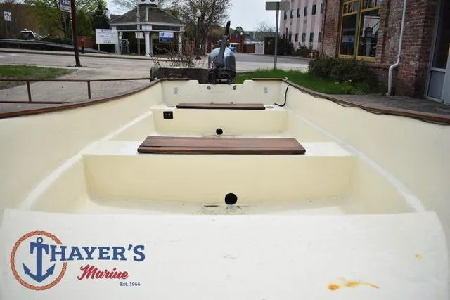 Slide: The Image of 1980 Carolina Skiff boat interior with wooden seats, displayed at Thayer's Marine. - 13