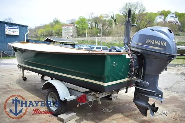 Slide: The Image of 1980 Carolina Skiff boat on trailer with Yamaha outboard motor, parked outdoors. - 3