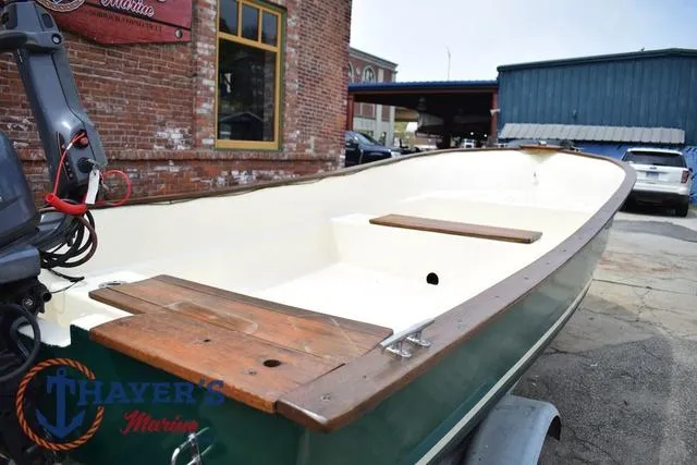 Slide: The Image of 1980 Carolina Skiff boat with wooden seats, parked outside Thayer's Marine. - 9