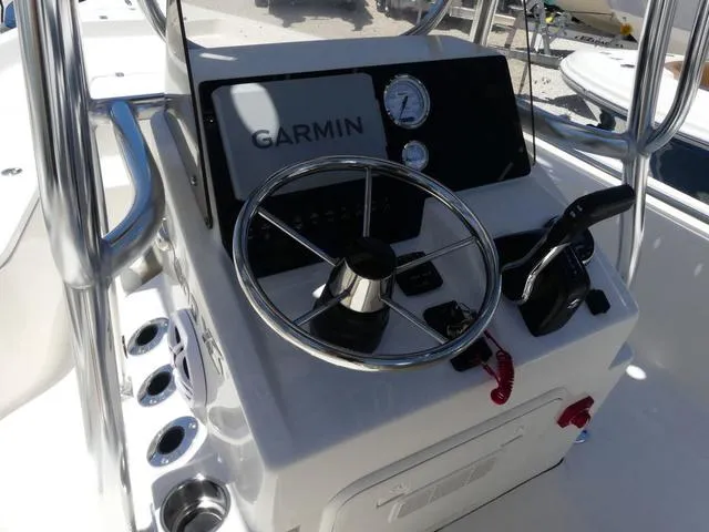 Slide: The Image of 2025 Bulls Bay 2200XS boat console with Garmin navigation and steering wheel. - 10