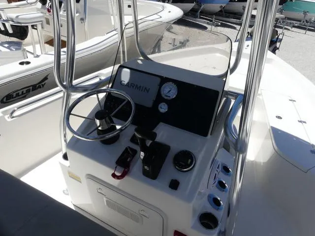 Slide: The Image of 2025 Bulls Bay 2200XS boat console with Garmin navigation system and steering wheel. - 12