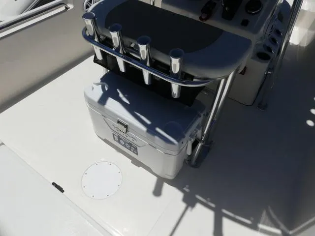 Slide: The Image of 2025 Bulls Bay 2200XS boat interior with rod holders and storage compartment. - 15