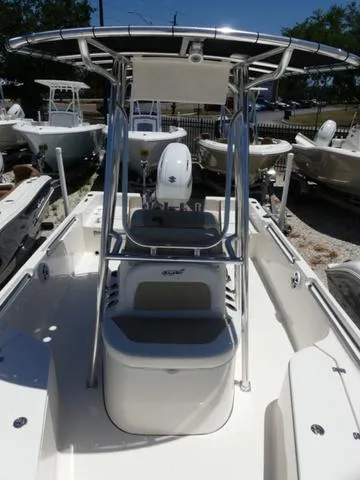 Slide: The Image of 2025 Bulls Bay 2200XS boat with T-top, center console, and seating, displayed outdoors. - 18