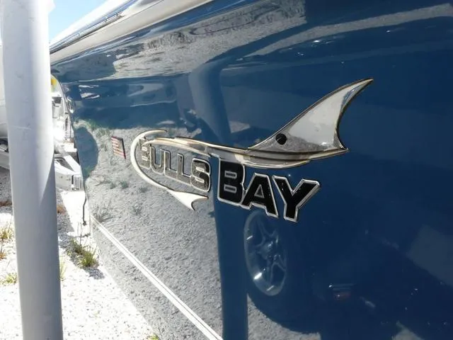 Slide: The Image of 2025 Bulls Bay 2200XS boat logo on blue hull. - 5
