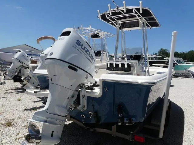 Slide: The Image of 2025 Bulls Bay 2200XS boat with Suzuki outboard motor, parked on gravel lot. - 7