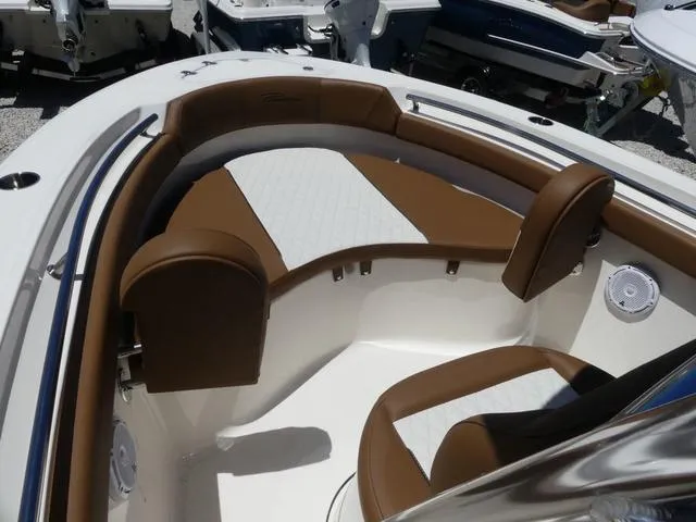 Slide: The Image of 2025 Pioneer ISLANDER 202 boat interior with brown and white seating. - 10