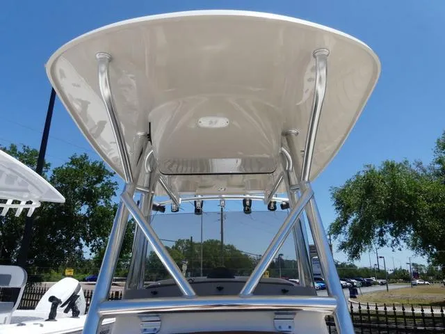 Slide: The Image of 2025 Pioneer ISLANDER 202 boat with sleek T-top design under clear blue sky. - 12