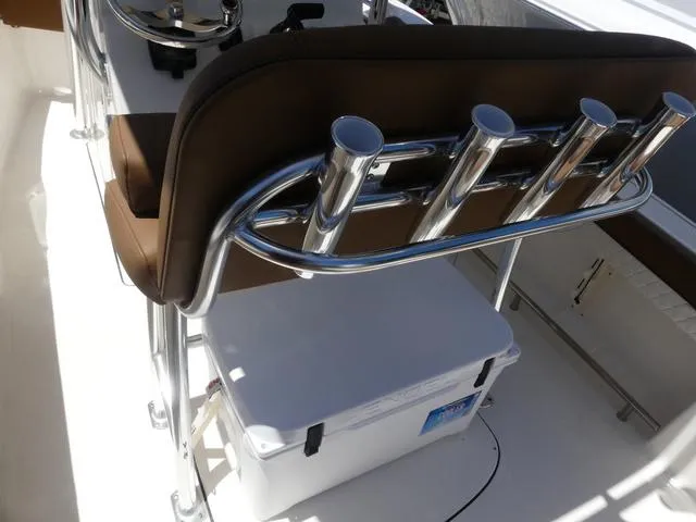 Slide: The Image of 2025 Pioneer ISLANDER 202 boat interior with rod holders and cooler storage. - 13